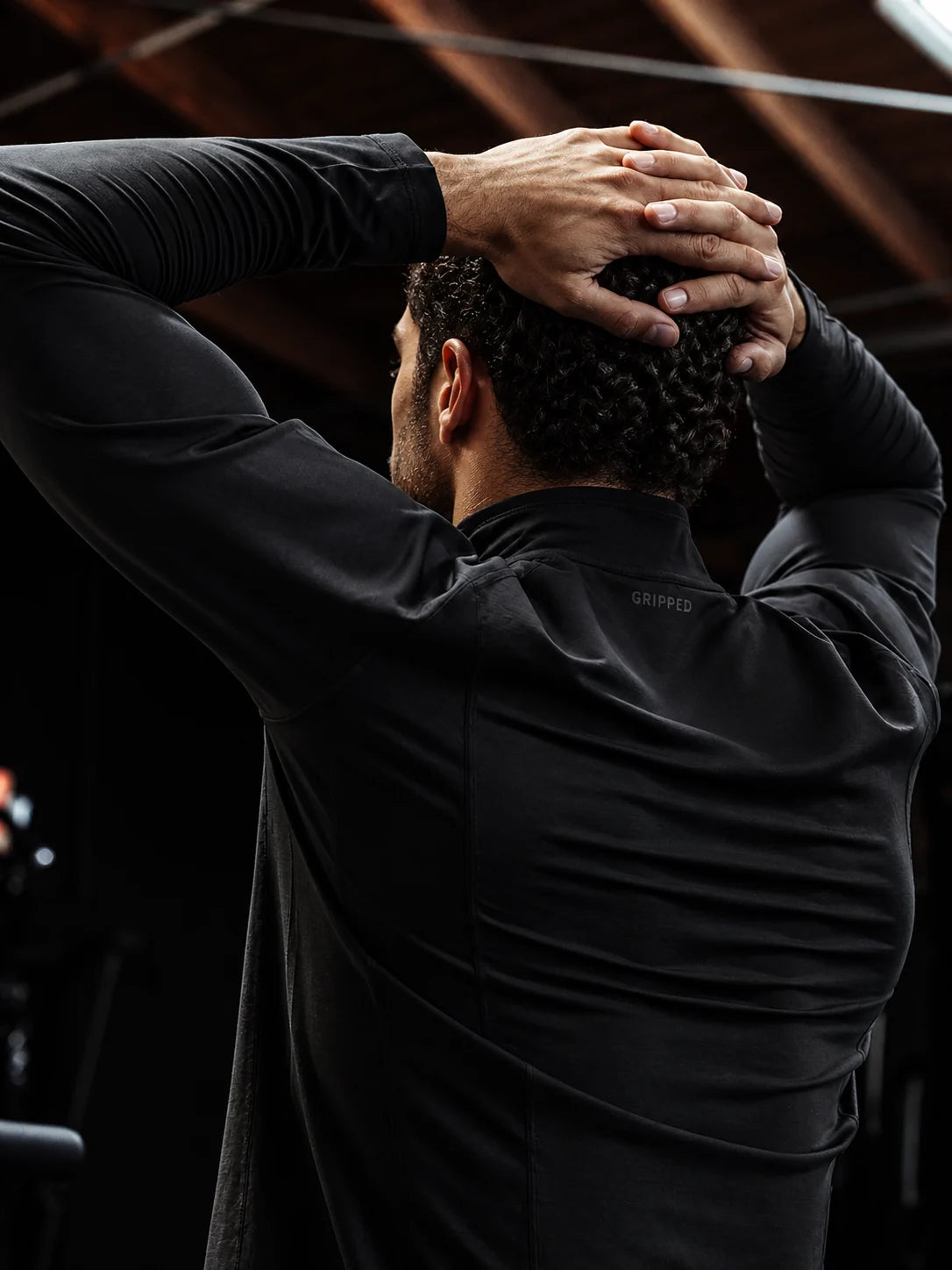 Black quarter zip — subtle Gripped branding at the back